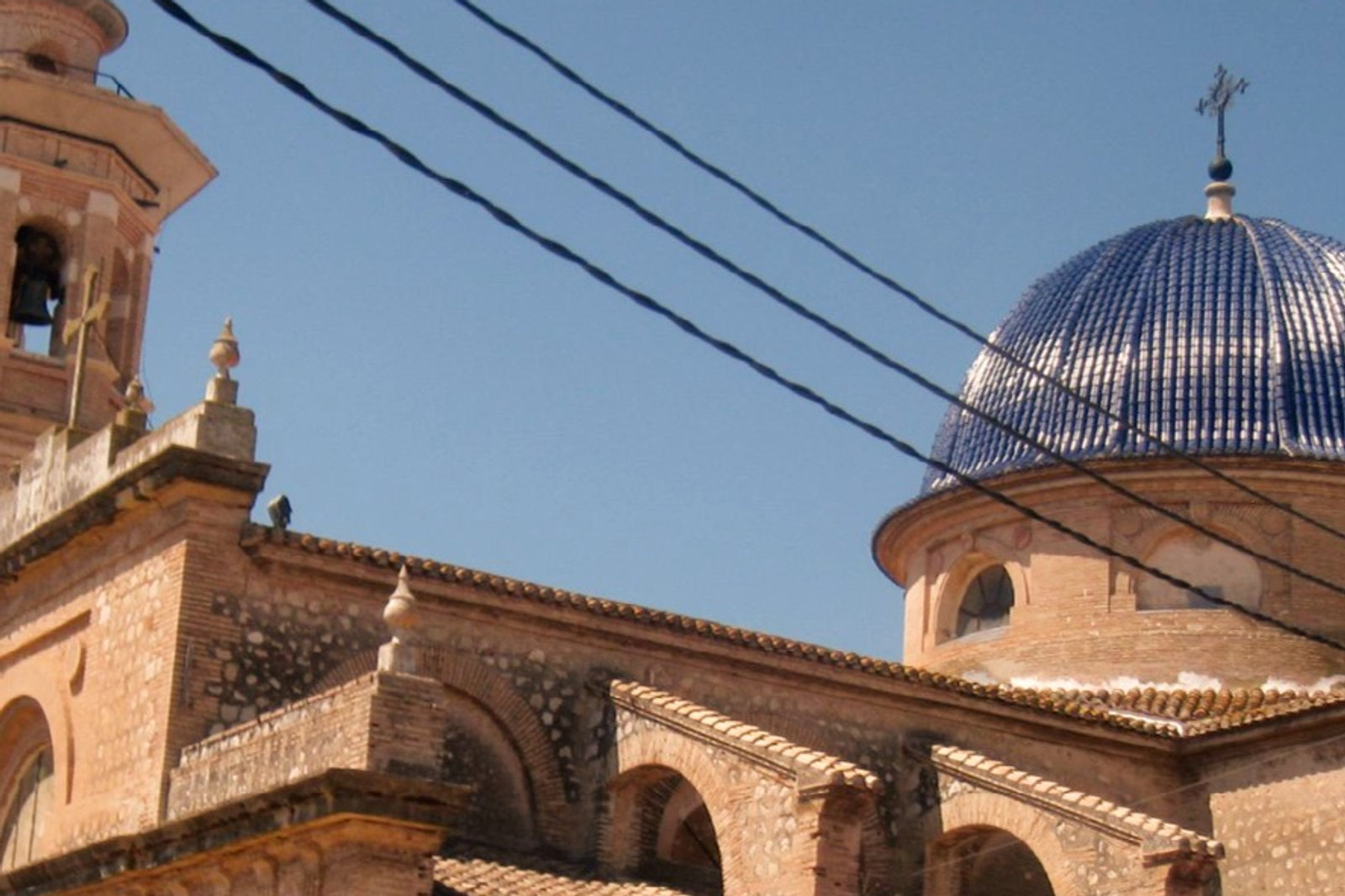 The blue-domed church of a Costa Blanca village under clear skies
