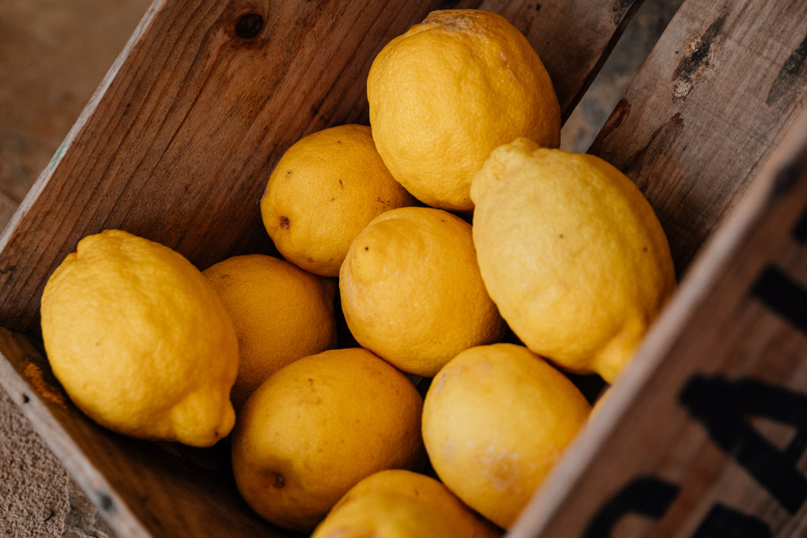 Fresh lemons from the valley in a wooden crate
