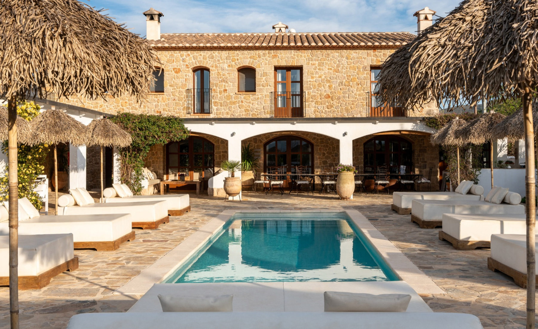 The pool at Cuatre Finques with loungers and mountain views