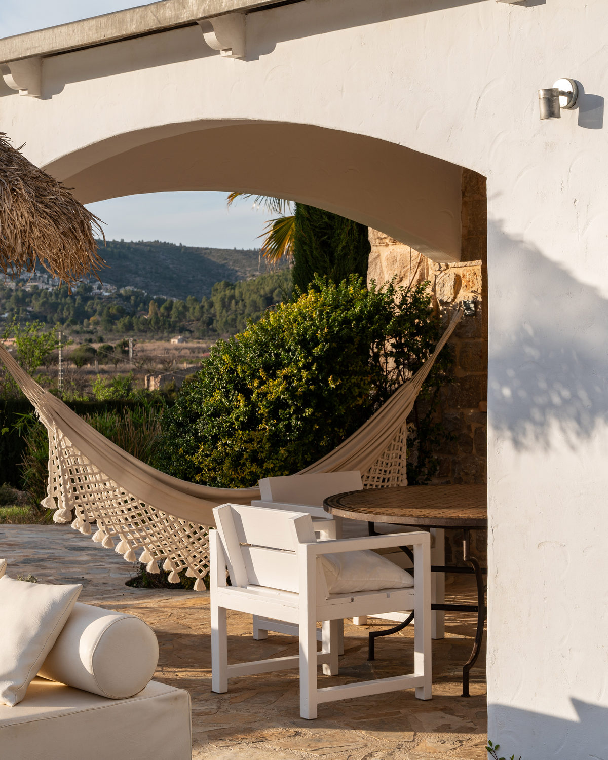 Shaded terrace with a hammock beside the stone finca